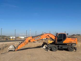 Услуги колёсного экскаватора Develon 210